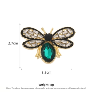Detail view of cute gold bee brooch with green gem and crystals measuring 3.8cm x 2.7cm