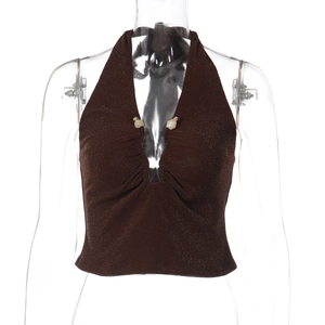 Detail of dark brown halter top featuring sparkly fabric and round bead accents on V-neckline