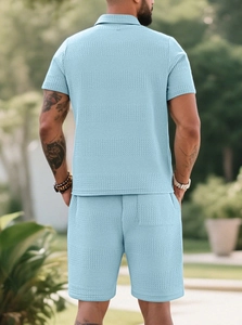 Outdoor back view of men's light blue waffle knit polo shirt and shorts set