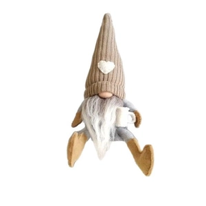 Nordic Christmas gnome plush with knitted hat and coffee cup on white background
