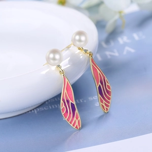 Elegant wing earrings with gradient enamel wings and white pearls on golden metal base