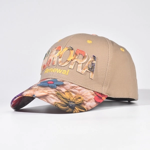 Detail of floral embroidery on the brim of a khaki Aurora Renewal baseball cap