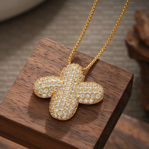 Macro shot of 18K gold plated four-leaf clover pendant necklace with cubic zirconia pave