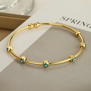 Brazalete dorado ajustable con dijes de mal de ojo en esmalte turquesa para mujer