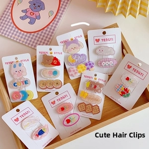 Close-up of cute cartoon resin hair clips with bears and flowers on display cards