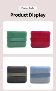 Detail of square flocked powder puffs in four colors with wide satin finger straps