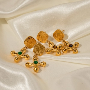 Elegant 18k gold plated stainless steel cross earrings with tiger eye stone on white silk