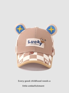 Detail view of khaki checkered kids baseball cap with bear ears and Lucky label