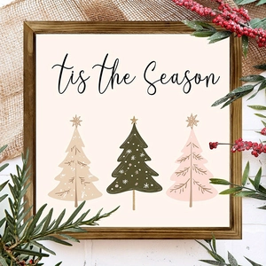 Close-up of wooden frame with 'Tis the Season' text and stylized colorful Christmas trees