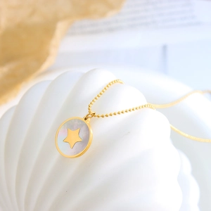Golden titanium steel necklace with star pattern on shell pendant on white background