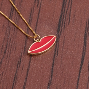 Detailed view of a gold-plated necklace featuring a red enamel lip pendant on leather