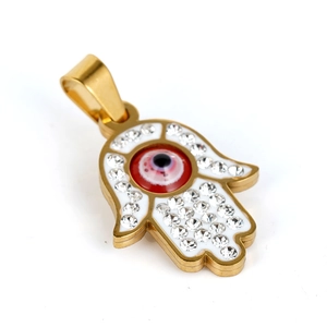 Macro view of gold Hamsa hand pendant with red evil eye and white enamel inlay