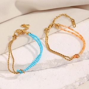 Detail of 18K gold plated twist chain bracelets with sky blue and orange natural stones