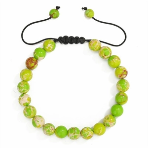 Detailed macro view of 8mm green natural stone beads on a black braided adjustable bracelet