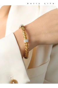 Close-up of golden woven texture open cuff bracelet with micro-pave zircon accents