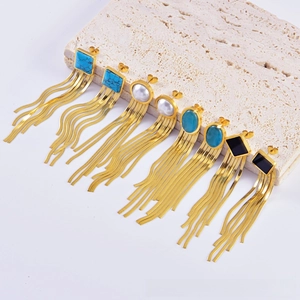 Detailed view of four pairs of vintage gold tassel earrings with turquoise and pearls