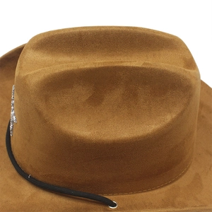 Detail of brown suede cowboy hat with silver star badge and black windproof cord