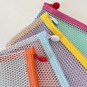Close-up of lightweight honeycomb mesh pencil bags with colorful contrasting zippers