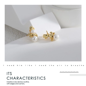 Detailed close-up of snowman-shaped gold-plated stud earrings with elegant white pearls