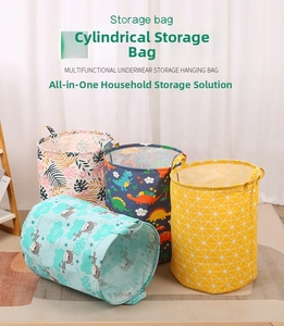 Detail of four large capacity fabric laundry baskets with bear and dinosaur patterns