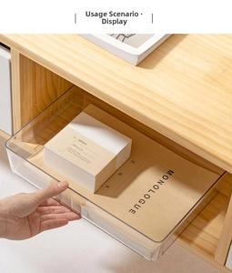 Close-up of clear acrylic drawer organizer showing smooth gliding on wooden cabinet slides