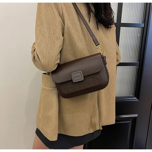 Detail showing dark brown leather and suede stitching with premium hardware buckle