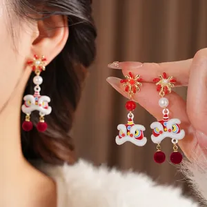 Festive Lion Dance earrings with pearls and red plush balls for a Chinese New Year look