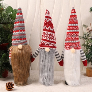 Three Christmas gnomes with knitted hats and faux fur beards for holiday table decor