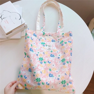 Detailed close-up of floral canvas bag fabric featuring colorful abstract flower patterns