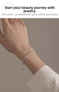 Detailed close-up of a silver geometric chain bracelet with textured block design for women