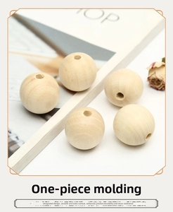 Close-up of five smooth natural wood beads with pre-drilled holes for DIY jewelry
