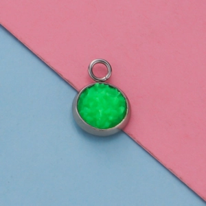 Macro shot of 12mm silver stainless steel pendant with textured green druzy inlay