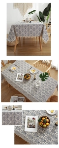Detail of blue and white vintage floral pattern on cotton linen tablecloth with tassels