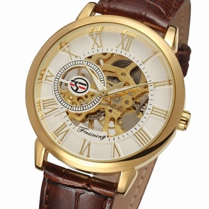 Close-up of golden skeleton mechanical watch with Roman numerals and brown leather strap
