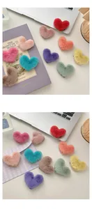 Detail shot of heart-shaped plush hair clips in assorted macaron colors for women