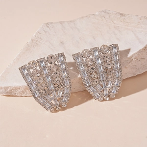 Macro detail of silver geometric stud earrings with sparkling baguette cut zircons