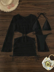 Flat lay of black 3-piece mesh bikini set with long sleeve cover-up on wood background