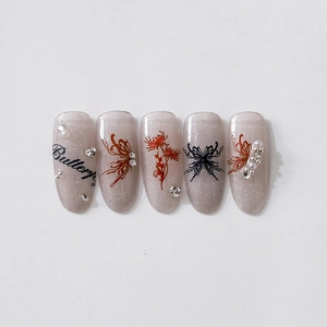 Silver glitter press-on nails with black butterfly and red flower embossed patterns