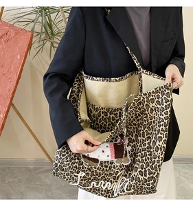Detail of leopard print tote bag featuring internal compartments and puppy embroidery