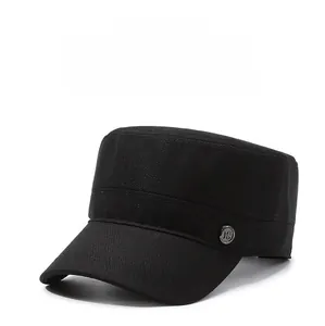 Detail of black cotton flat top military cap with side metal emblem decoration