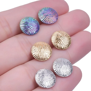 Macro shot of 304 stainless steel wave earrings in gold, silver, rainbow and rose gold