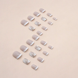 Short square press-on nails with nude pink French tips and golden marble line patterns
