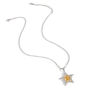Detailed view of silver and gold two-tone star pendant necklace on a white background