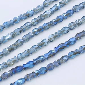 Macro shot of blue faceted fish-shaped crystal beads for DIY jewelry making