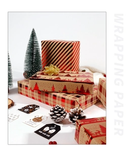 Detail of red and gold Christmas wrapping paper with festive tree and stripe patterns