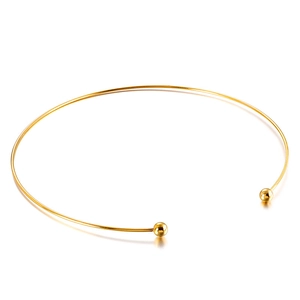 Minimalist gold C-shaped titanium steel collar necklace with decorative spheres on white background