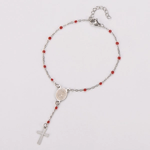 Detailed view of religious rosary bracelet with red beads and silver Virgin Mary medal