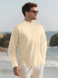 Detail of cream linen shirt with mandarin collar shown in beach setting with natural light