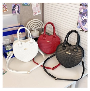 Trois sacs à main en forme de cœur à motif crocodile en blanc, rouge et noir avec détails dorés