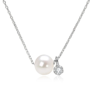 Macro detail of natural white pearl and small zircon pendant on a silver necklace chain